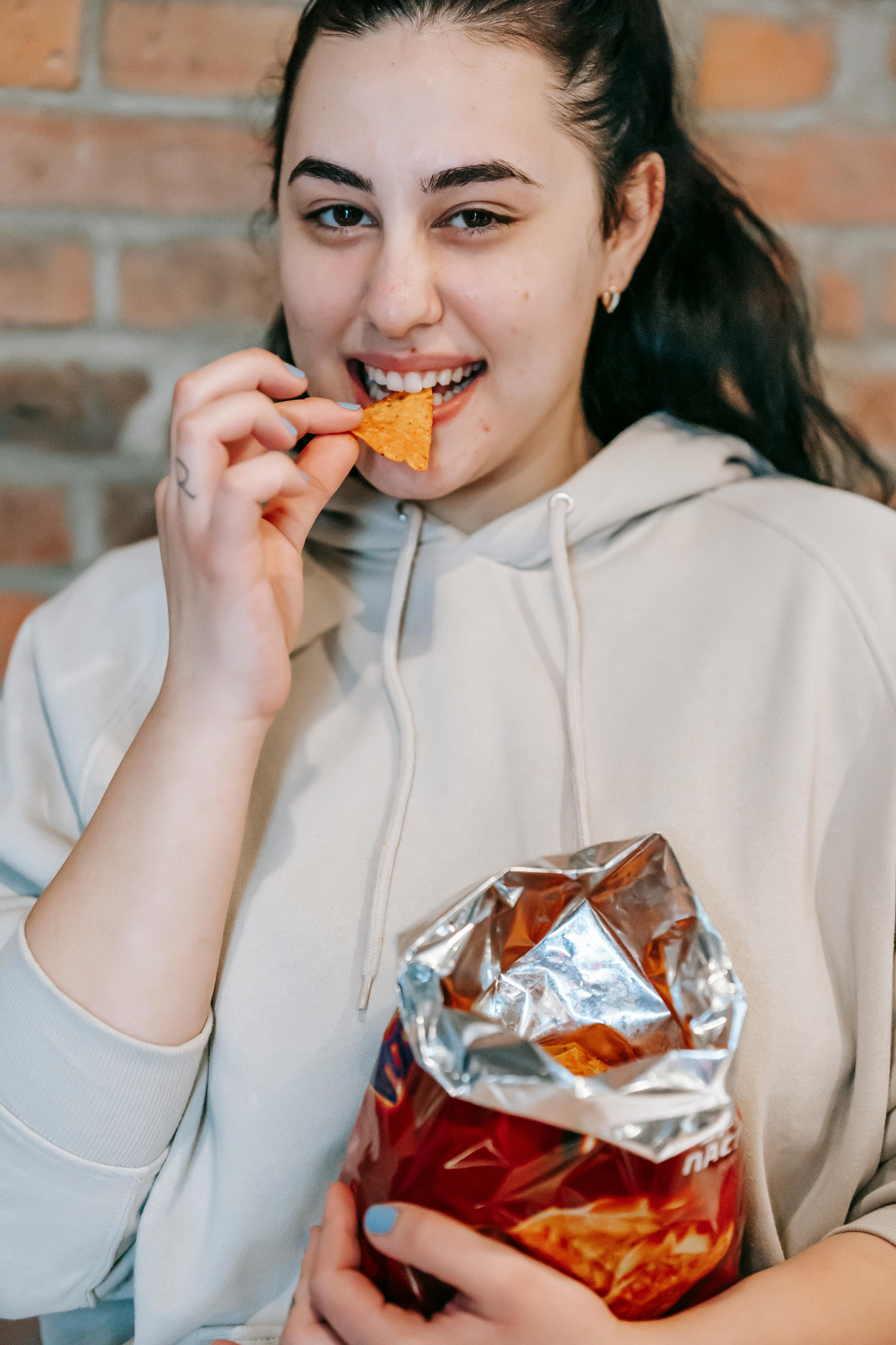Woman enjoying STEAK FUEL air-cured biltong straight from the bag.